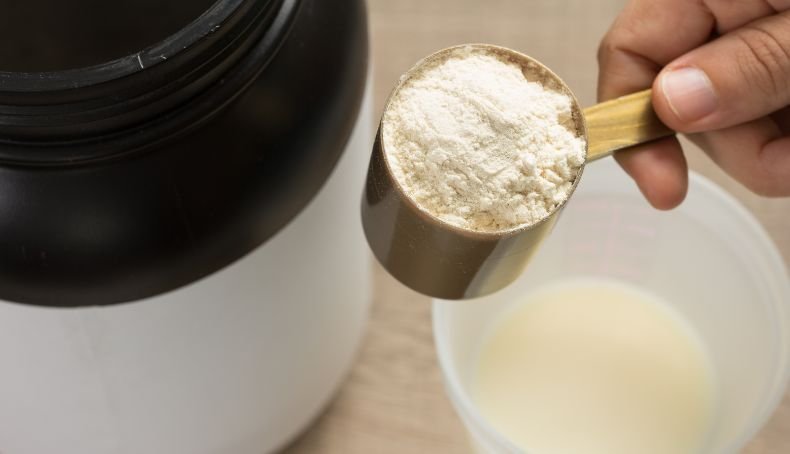 Mano Sosteniendo Un Scoop de Proteína en Polvo